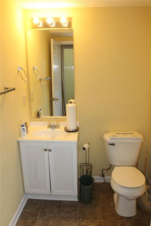 bathroom with vanity, tile patterned floors, and toilet