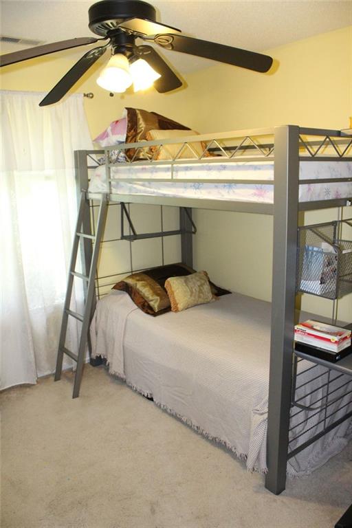 bedroom featuring ceiling fan and carpet floors