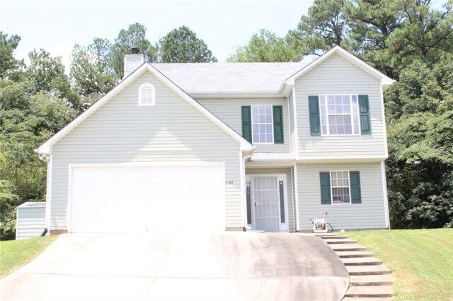 view of front of house featuring a garage and a front yard