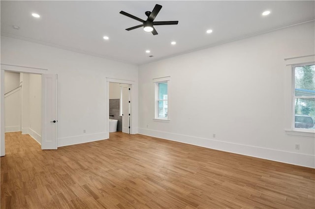 empty room featuring ceiling fan, light hardwood / wood-style floors, and crown molding