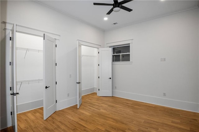 unfurnished bedroom featuring ceiling fan, ornamental molding, and light hardwood / wood-style flooring