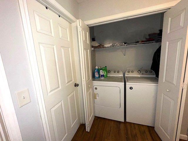 laundry room featuring dark hardwood / wood-style flooring and washing machine and clothes dryer