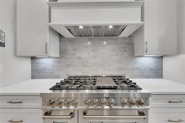 kitchen with decorative backsplash, custom exhaust hood, and range with two ovens