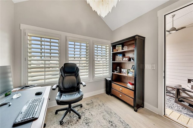 office space featuring lofted ceiling and light hardwood / wood-style flooring