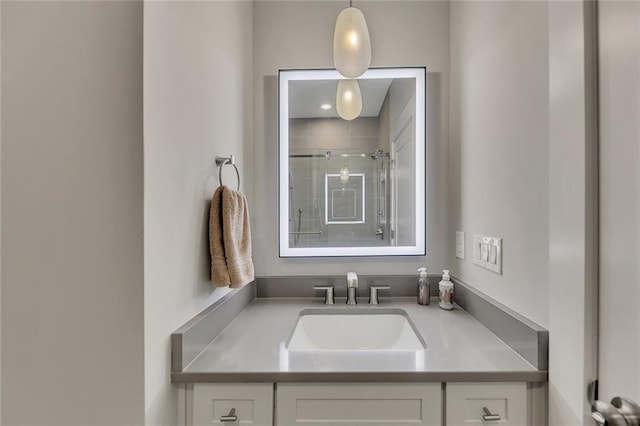 bathroom featuring vanity and a shower with shower door