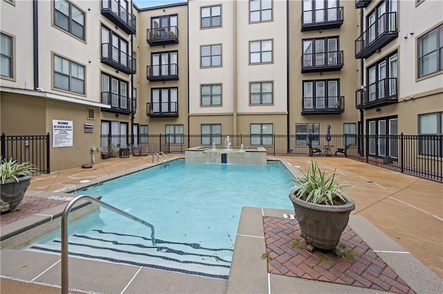 view of swimming pool with a community hot tub