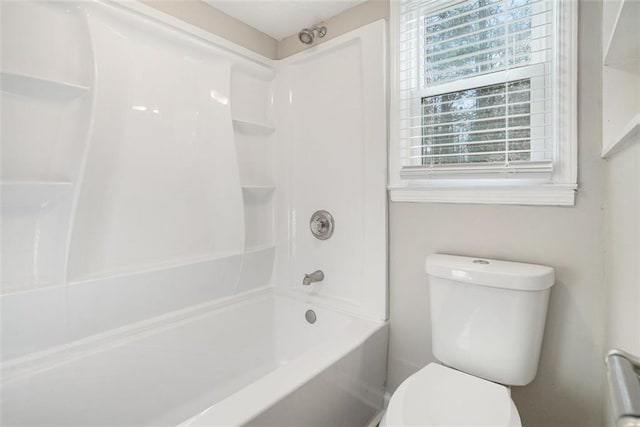 bathroom with toilet and washtub / shower combination