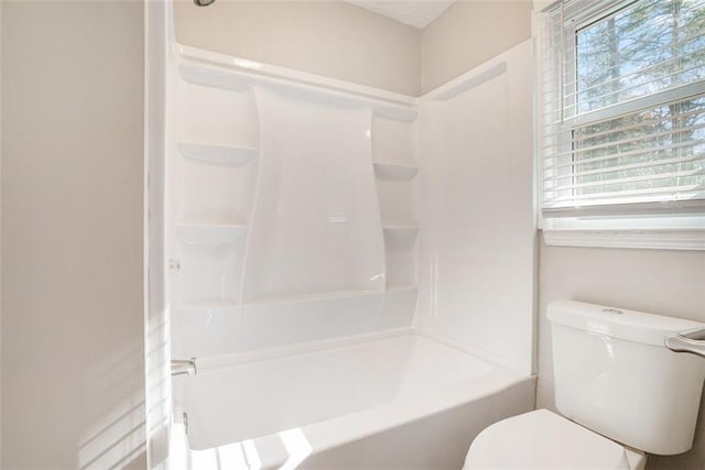 bathroom featuring toilet and tub / shower combination