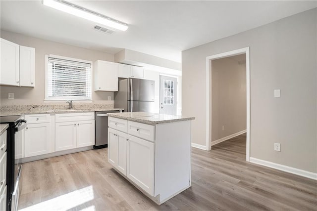 kitchen featuring a center island, white cabinetry, and stainless steel appliances