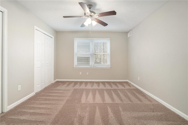 unfurnished bedroom featuring carpet, a closet, and ceiling fan