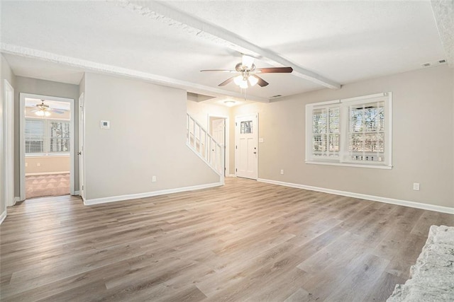 unfurnished room with ceiling fan, hardwood / wood-style floors, and beamed ceiling