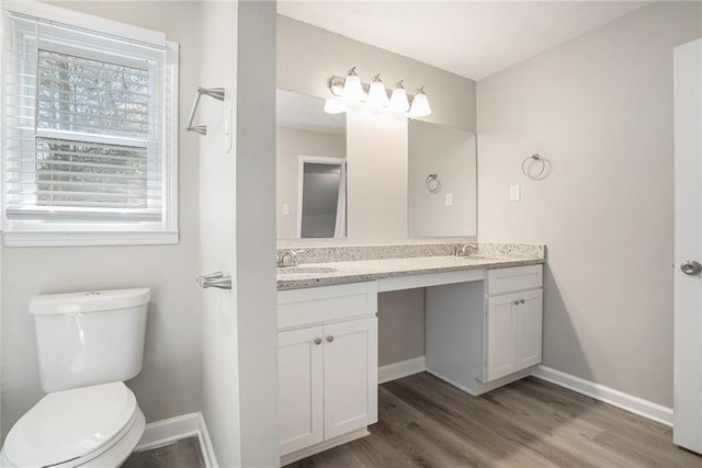 bathroom featuring hardwood / wood-style floors, vanity, and toilet