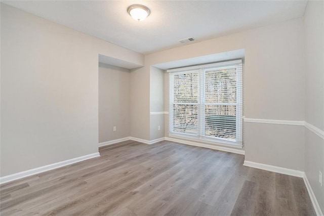 spare room with light hardwood / wood-style floors