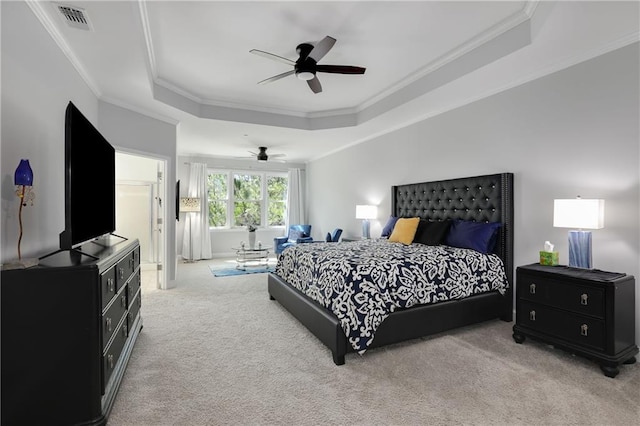 bedroom featuring a ceiling fan, visible vents, a tray ceiling, carpet, and crown molding