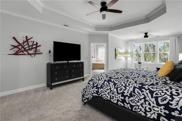 bedroom featuring ornamental molding, a tray ceiling, baseboards, and carpet