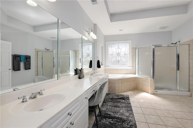 bathroom with a garden tub, double vanity, a sink, a shower stall, and tile patterned flooring