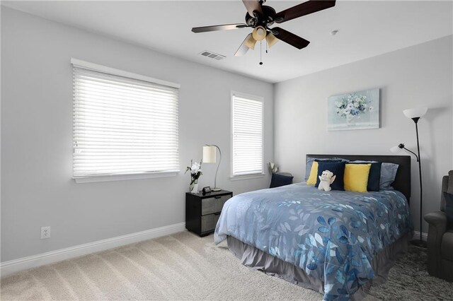 bedroom featuring carpet, visible vents, baseboards, and ceiling fan