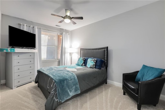 bedroom featuring a ceiling fan, light colored carpet, visible vents, and baseboards