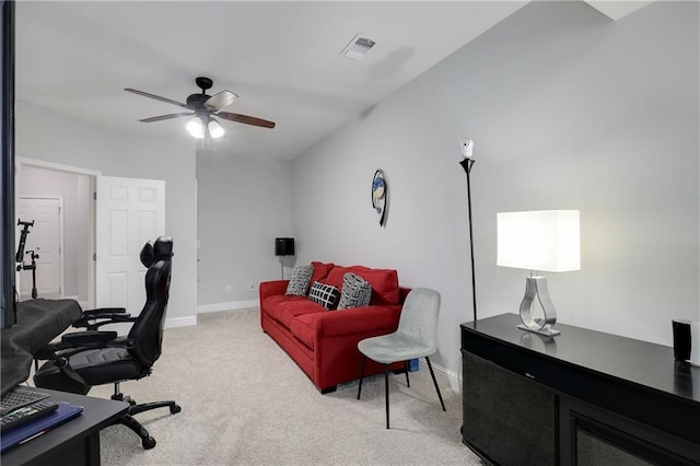 home office featuring light carpet, ceiling fan, visible vents, and baseboards