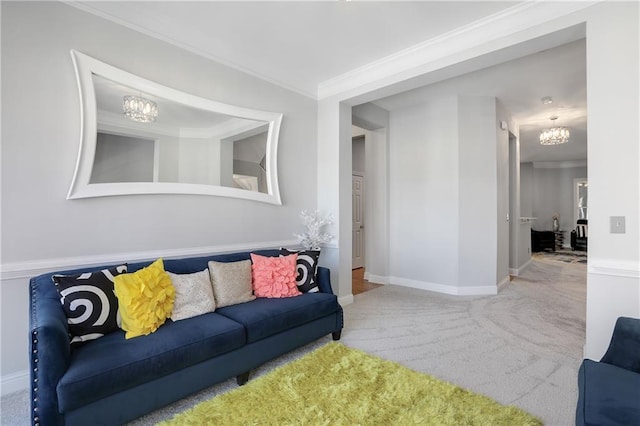 carpeted living room with baseboards, ornamental molding, and a notable chandelier