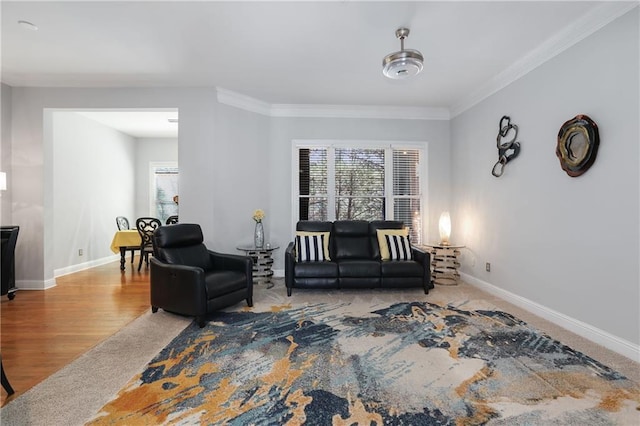 carpeted living room with baseboards, crown molding, and wood finished floors