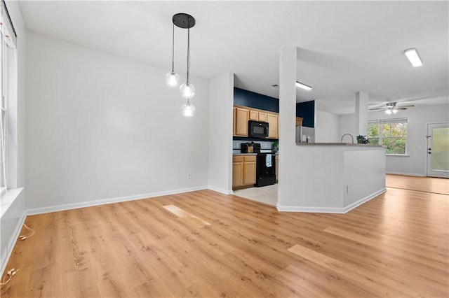 unfurnished living room featuring light hardwood / wood-style floors and ceiling fan