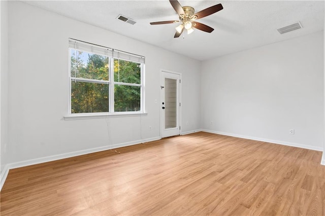 spare room featuring ceiling fan and light hardwood / wood-style flooring