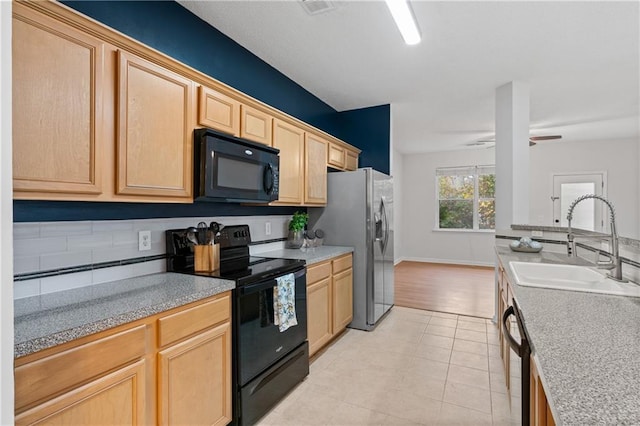 kitchen featuring black appliances, sink, ceiling fan, light wood-type flooring, and light brown cabinetry