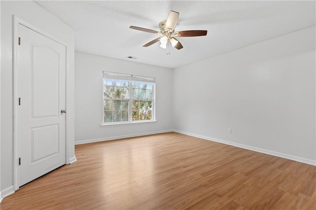 interior space featuring ceiling fan, a textured ceiling, and light wood-type flooring