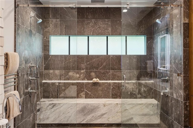 full bathroom featuring a healthy amount of sunlight and tiled shower