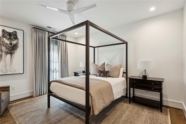 bedroom featuring baseboards, wood finished floors, visible vents, and recessed lighting