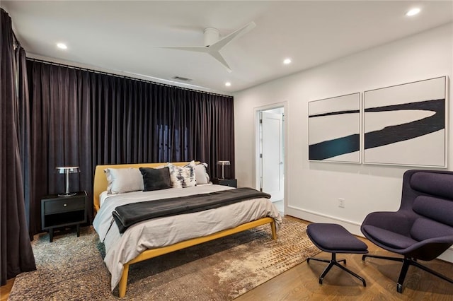 bedroom with a ceiling fan, visible vents, wood finished floors, and recessed lighting