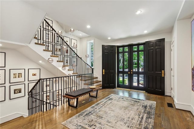 entryway with recessed lighting, visible vents, baseboards, and wood finished floors