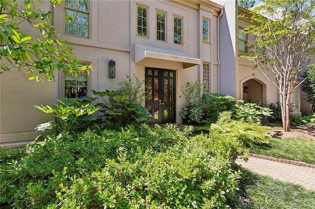 doorway to property with french doors and stucco siding