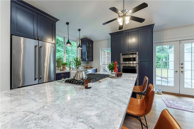 657 E Paces Ferry Rd NE, Atlanta, GA 30305 - kitchen featuring appliances with stainless steel finishes, ceiling fan, light stone counters, and plenty of natural light