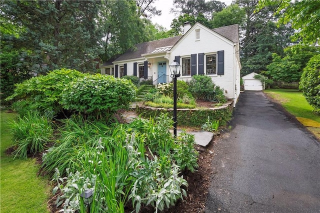 657 E Paces Ferry Rd NE, Atlanta, GA 30305 - view of front of property with an outbuilding, a chimney, and a detached garage