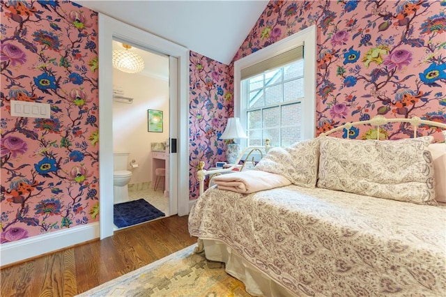 657 E Paces Ferry Rd NE, Atlanta, GA 30305 - bedroom featuring wallpapered walls, wood finished floors, lofted ceiling, and ensuite bath