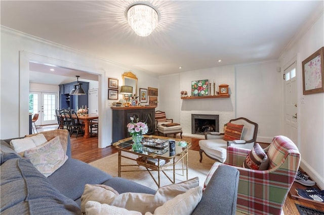 657 E Paces Ferry Rd NE, Atlanta, GA 30305 - living area with wood finished floors, a fireplace, ornamental molding, a chandelier, and french doors