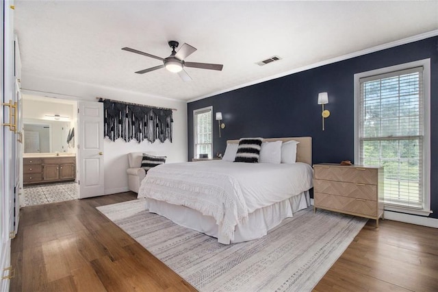 1452 Crooked Tree Cir, Stone Mountain, GA 30088 - bedroom featuring wood finished floors, ceiling fan, ensuite bath, and crown molding