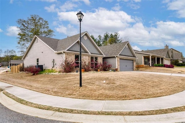 view of front of property with a garage, driveway, a front yard, and brick siding