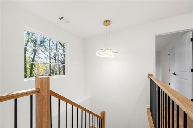 hallway with a chandelier