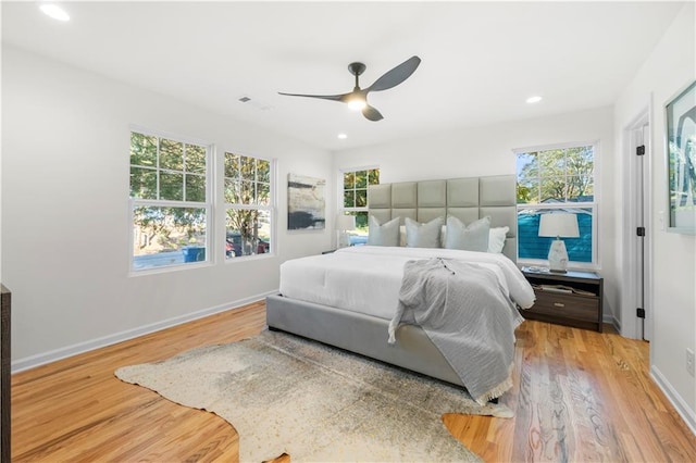 bedroom with light wood-type flooring and ceiling fan