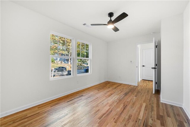 empty room featuring ceiling fan and light wood-type flooring