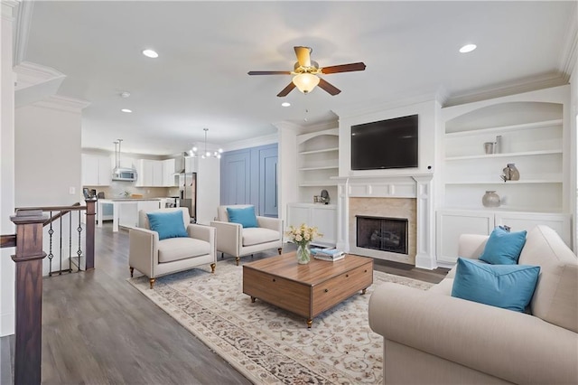 living area featuring ornamental molding, recessed lighting, and wood finished floors