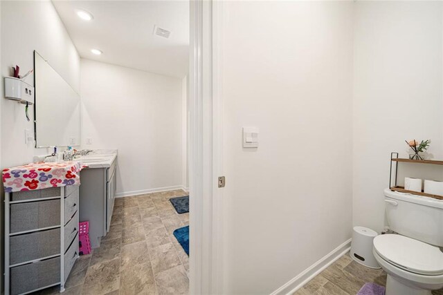2030 Vidalia Ct, Dacula, GA 30019 - bathroom with toilet, recessed lighting, vanity, and baseboards