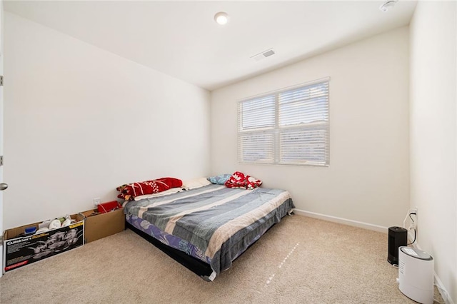 bedroom with carpet floors, visible vents, and baseboards