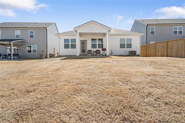 2030 Vidalia Ct, Dacula, GA 30019 - back of property featuring a lawn, fence, and central air condition unit