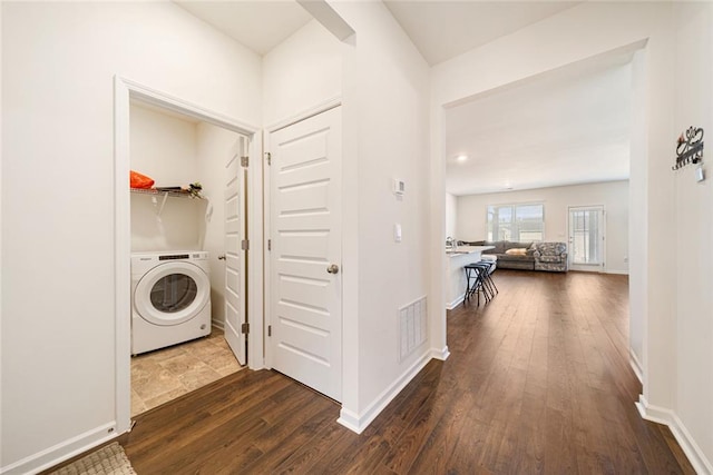 laundry area with dark wood-style flooring, visible vents, washer / dryer, laundry area, and baseboards