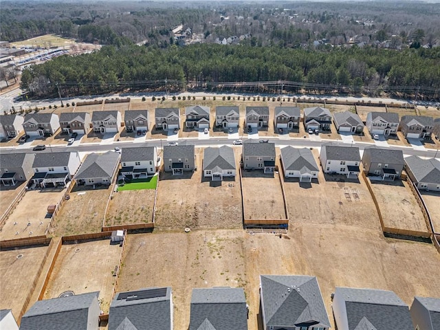 drone / aerial view featuring a forest view and a residential view