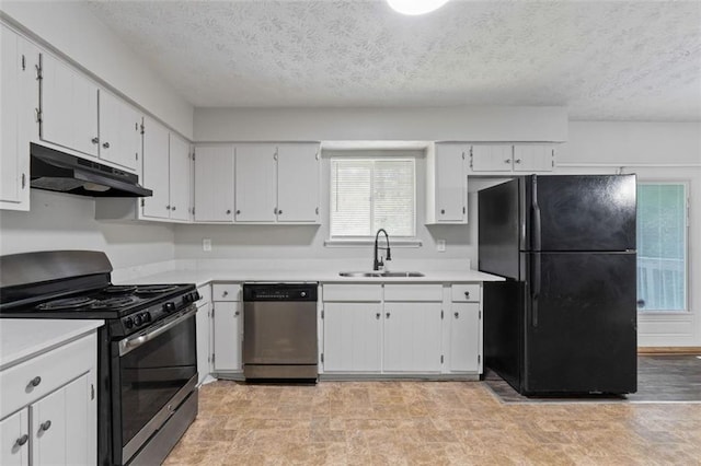 kitchen with white cabinets, sink, stainless steel appliances, and a textured ceiling